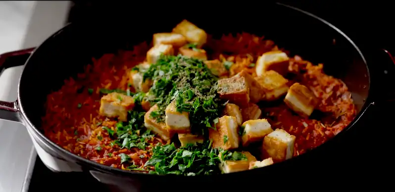 Spiced kitchari with tofu and red rice, a wholesome, flavorful Ayurvedic meal packed with nutritious veggies and spices.